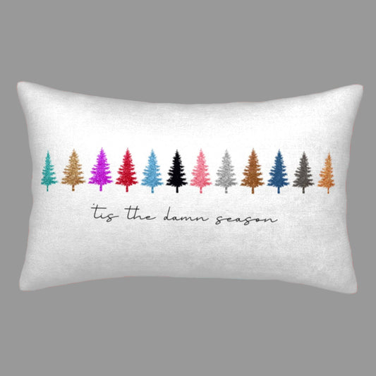 Decorative pillow with colorful Christmas tree design and text on a white background