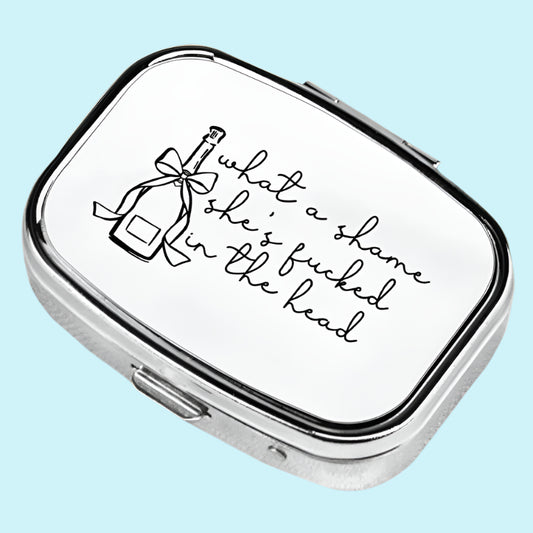 Small rectangular metal container with text on a blue background