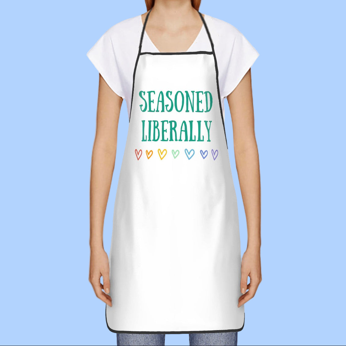 Person wearing a white apron with 'Seasoned Liberally' text and colorful hearts on a white background