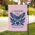 Pink garden flag with butterfly design and text on a grassy lawn